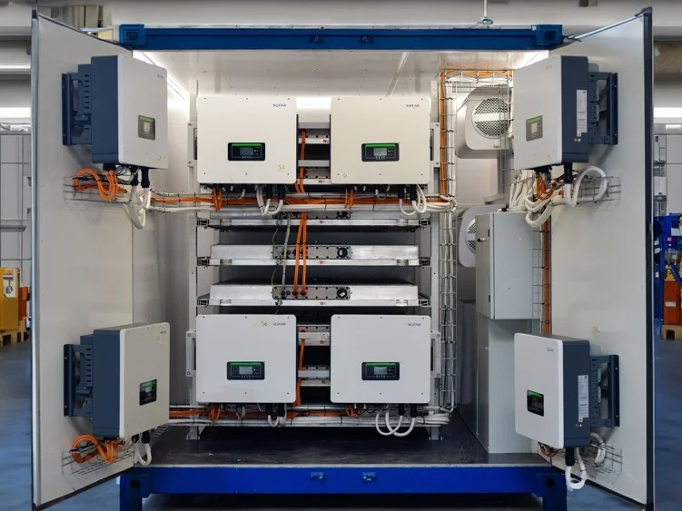 Open Marny Battery-Shelter in the Lyon workshop: battery racks, inverters and cabling inside